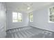 Well-lit bedroom with gray carpet and two windows at 4217 Grahamstone Rd, Raleigh, NC 27610