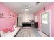 Bright bonus room with pink walls, ideal for a salon, complemented by stylish furnishings and ample natural light at 4217 Grahamstone Rd, Raleigh, NC 27610