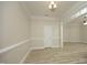 Dining room features light-colored walls, wood-look flooring, and a chandelier at 4217 Grahamstone Rd, Raleigh, NC 27610