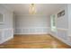 Formal dining room with hardwood floors, chandelier lighting, wainscoting, and ample space for entertaining at 4217 Grahamstone Rd, Raleigh, NC 27610