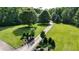 Long paved driveway with stone column entrance and mature landscaping at 4217 Grahamstone Rd, Raleigh, NC 27610