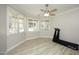 Sun-filled exercise room with wood floors features a ceiling fan and treadmill at 4217 Grahamstone Rd, Raleigh, NC 27610