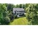 An aerial view of a beautifully landscaped home with a large lawn and surrounding trees at 4217 Grahamstone Rd, Raleigh, NC 27610