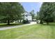 A view of the side of the house with a long driveway leading to the garage at 4217 Grahamstone Rd, Raleigh, NC 27610