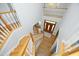 A high angle view of the foyer with a beautiful wooden door and staircase leading to the upper floors at 4217 Grahamstone Rd, Raleigh, NC 27610