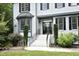 Front entrance with a brick walkway, decorative landscaping and charming black shutters on a two-story home at 4217 Grahamstone Rd, Raleigh, NC 27610
