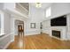 Bright living room featuring a fireplace, hardwood floors, and seamless flow to other areas of the home at 4217 Grahamstone Rd, Raleigh, NC 27610
