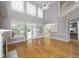Open living room featuring hardwood floors, a high ceiling, and large windows for plenty of natural light at 4217 Grahamstone Rd, Raleigh, NC 27610
