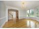 Open-concept living room with hardwood floors, view of foyer, and staircase at 4217 Grahamstone Rd, Raleigh, NC 27610
