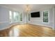 Bright living room features hardwood floors, large windows, and a stylish chandelier at 4217 Grahamstone Rd, Raleigh, NC 27610