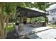 Well-equipped outdoor kitchen with stone counters, fireplace and bar seating is perfect for entertaining at 4217 Grahamstone Rd, Raleigh, NC 27610