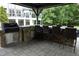 This outdoor kitchen area features a built-in grill, bar with seating, and plenty of space for entertaining guests at 4217 Grahamstone Rd, Raleigh, NC 27610