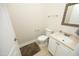 Powder room features tile floors, granite countertop, and white fixtures at 4217 Grahamstone Rd, Raleigh, NC 27610
