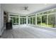 Bright sunroom with large windows, ceiling fan, and views of the backyard at 4217 Grahamstone Rd, Raleigh, NC 27610