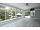 Sunroom has large windows offering backyard views of an outdoor lounge area at 4217 Grahamstone Rd, Raleigh, NC 27610