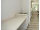 Wet bar featuring a countertop and cabinet storage adjacent to a doorway at 4217 Grahamstone Rd, Raleigh, NC 27610