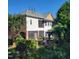 The back exterior showcasing a multi-story home with a patio, lush landscaping, and a serene backyard setting at 502 Willowmere Ct, Cary, NC 27513