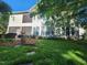 Charming back exterior with a screened balcony overlooking a lush green lawn at 502 Willowmere Ct, Cary, NC 27513