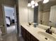 Bathroom featuring a double vanity with under-cabinet storage, a large mirror, and shower at 502 Willowmere Ct, Cary, NC 27513