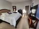 A comfortable bedroom features a large bed, side tables, a dresser, and a television at 502 Willowmere Ct, Cary, NC 27513