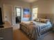 Bright bedroom featuring a bed with plush bedding and a view into the bathroom at 502 Willowmere Ct, Cary, NC 27513