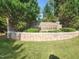 A welcoming community sign amid lush greenery invites you to Highland Oaks at 502 Willowmere Ct, Cary, NC 27513
