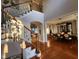 Grand foyer featuring hardwood floors, staircase with iron balusters, and an open dining area at 502 Willowmere Ct, Cary, NC 27513