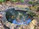 A serene backyard koi pond creates a peaceful outdoor space for relaxation at 502 Willowmere Ct, Cary, NC 27513