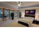 Spacious bedroom featuring large windows, ceiling fan, and a calming, neutral color palette at 502 Willowmere Ct, Cary, NC 27513