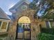 Stone archway leads to a pool area with ceiling fans and outdoor lighting at 502 Willowmere Ct, Cary, NC 27513
