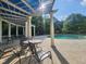 Relaxing poolside seating area with shaded pergola and community pool at 502 Willowmere Ct, Cary, NC 27513