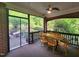 Spacious screened-in porch with a wooden dining table set, perfect for outdoor entertaining at 502 Willowmere Ct, Cary, NC 27513