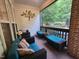 Cozy sunroom featuring comfortable wicker furniture and a view of the lush greenery outside at 502 Willowmere Ct, Cary, NC 27513