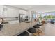 Open concept kitchen featuring a granite counter island with seating, stainless appliances, and abundant natural light at 509 Kildaire Farm Rd # 107, Cary, NC 27511