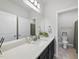 Well-lit bathroom with modern fixtures, white countertops, and a decorative mirror at 511 Kenton Mill Ct, Rolesville, NC 27571