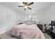 Bedroom with a ceiling fan, wall decor, exercise bike, and natural light at 511 Kenton Mill Ct, Rolesville, NC 27571