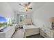 Bright bedroom features a ceiling fan, large window, desk, and a television at 511 Kenton Mill Ct, Rolesville, NC 27571