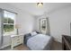 Serene bedroom with natural light and neutral decor offers a relaxing retreat at 511 Kenton Mill Ct, Rolesville, NC 27571