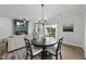 Cozy dining area with modern chandelier flows into living space with fireplace at 511 Kenton Mill Ct, Rolesville, NC 27571