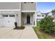 Inviting front porch with stone accents and a charming 'Welcome' sign enhances curb appeal at 511 Kenton Mill Ct, Rolesville, NC 27571