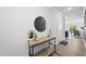 Entryway features a stylish table with decor, enhanced by a round mirror and bright, neutral walls at 511 Kenton Mill Ct, Rolesville, NC 27571