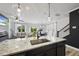 Modern kitchen island with a stainless steel sink overlooks the open living space at 511 Kenton Mill Ct, Rolesville, NC 27571