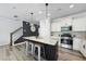 Contemporary kitchen with island seating, modern lighting, and stainless steel appliances at 511 Kenton Mill Ct, Rolesville, NC 27571