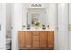 Charming bathroom with double vanity, modern lighting, and a large mirror reflecting the bedroom at 522 Johnson St, Garner, NC 27529