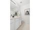 A crisp bathroom with a white vanity, black faucet, and framed art at 522 Johnson St, Garner, NC 27529