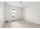 Bright bedroom with neutral carpet, white walls and natural light from the window at 522 Johnson St, Garner, NC 27529