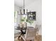 Close-up of dining area with modern chandelier, woven chairs, and stylish decor for an inviting meal setting at 522 Johnson St, Garner, NC 27529