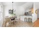 Open-concept living area with modern dining area and kitchen bar, promoting a seamless flow for gatherings and daily life at 522 Johnson St, Garner, NC 27529