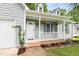 Inviting front porch with a white railing and a well-maintained garden at 522 Johnson St, Garner, NC 27529
