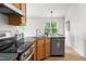 Traditional kitchen with stainless steel appliances, wood cabinets and efficient corner sink area to maximize space at 522 Johnson St, Garner, NC 27529
